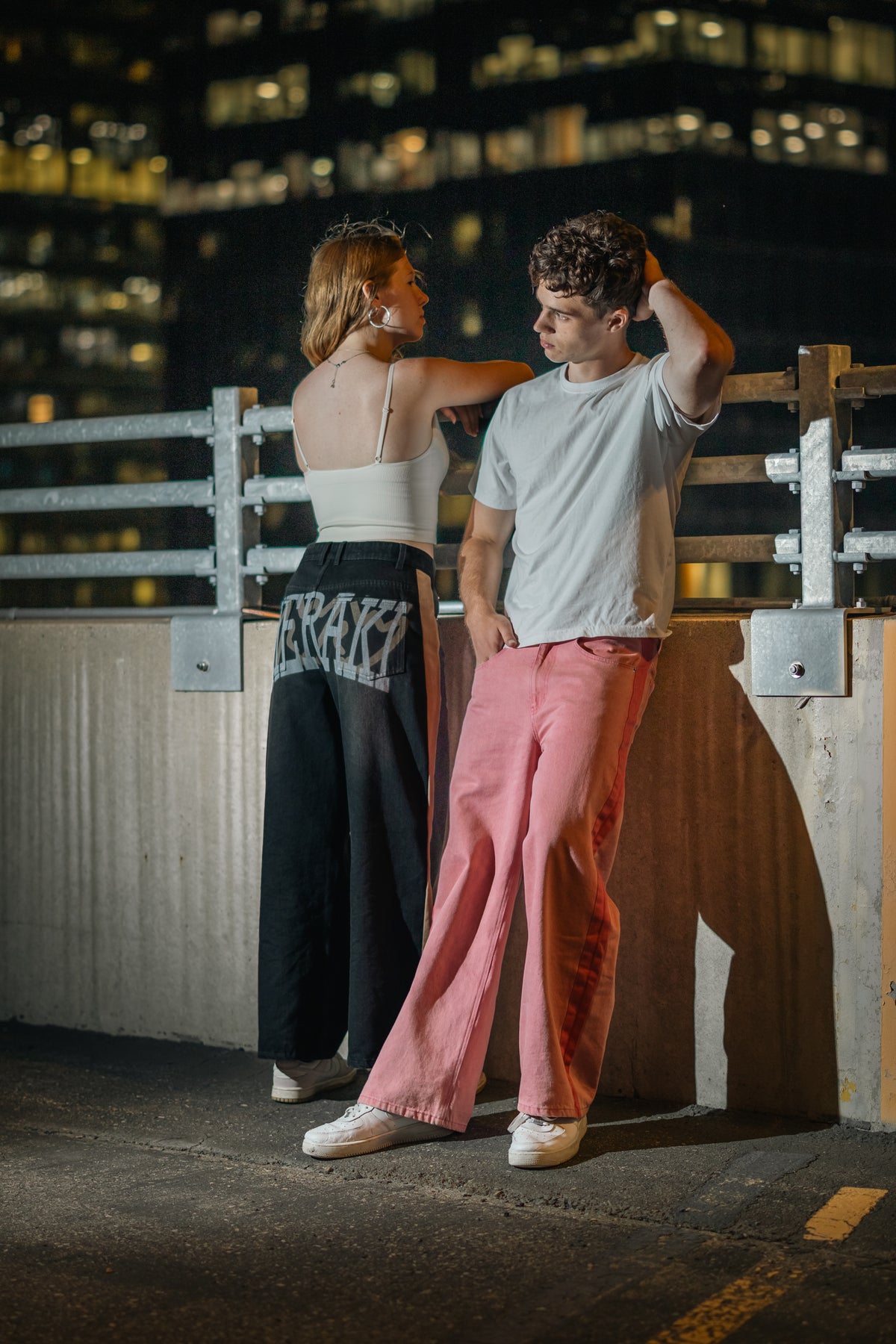 Meraki denim in Washed Pink and Washed Black on a rooftop at night